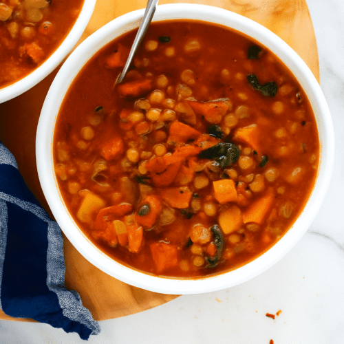Beste vegane Linsensuppe mit Tomaten und Grünkohl in weißer Schüssel